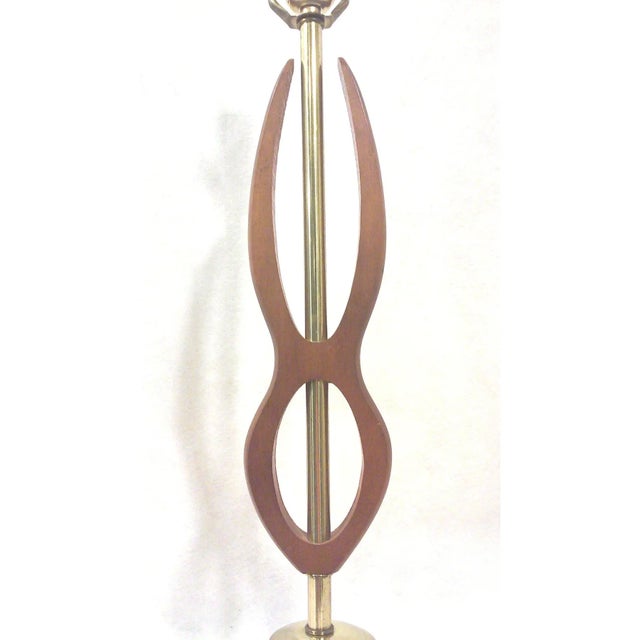A sculptural, Mid-Century walnut lamp with brass in a Mid Century Modern or Danish Modern style. The vintage lamp is in...