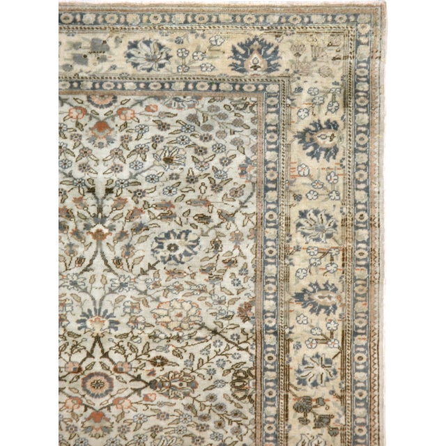 A vintage Turkish Sivas carpet from the mid-20th century. Thin vines and swirls of tiny leaves are the main ornamentations...