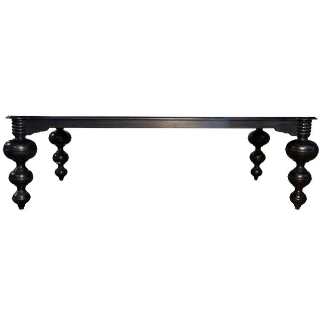 This spectacular dining table has been expertly hand-carved of solid mahogany with a deep, hand-rubbed black finish. Its...