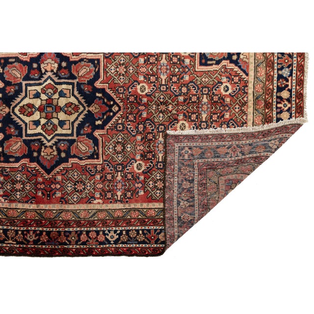 Elevate your interior with this striking vintage Hamadan rug, a masterpiece of traditional hand-knotted craftsmanship....