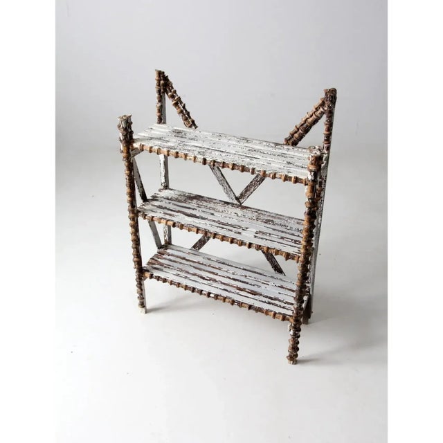 This is an antique spool art shelf featuring its original whitewashed finish, now beautifully mottled with age and wear....