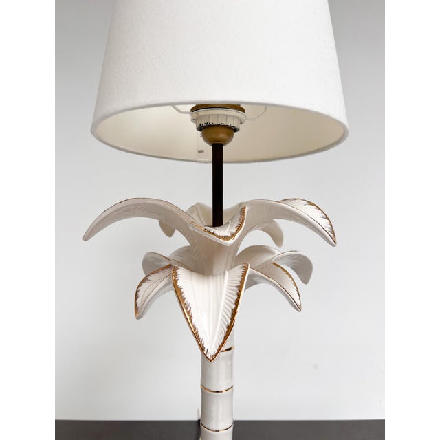Then you must take a good look at this table lamp! This striking palm tree-shaped lamp is made of white glazed ceramic...