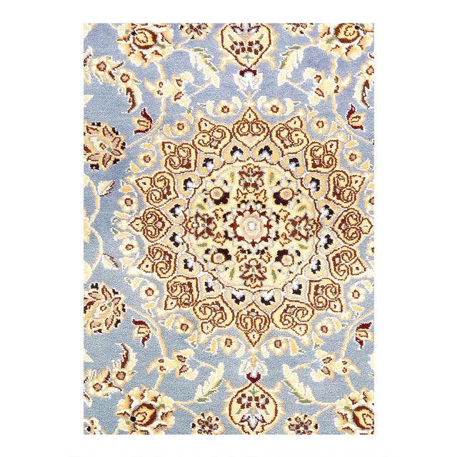 Persian Nain rugs are renowned for their detail and fine use of outlining along the central motifs. Breaking from the...