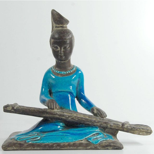 A highly decorative, oriental-style figurine made of colored ceramic. Additionally, it is decorated with a highly...