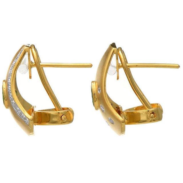 These fabulous tsavorite earrings are artistically decorated with sparkling diamonds that add an ornamental quality....