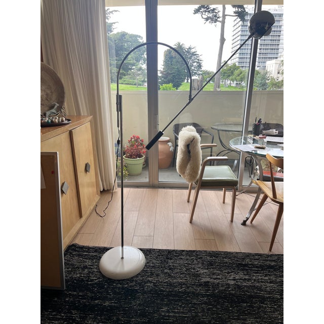 This lamp has been used by my family for the better part of two generations. A sculptural arc and counterbalanced arm...