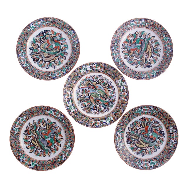 A lovely set of five polychrome and gilt decorated plates in the charming butterfly pattern. Well painted in greens, blue,...