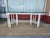 Elegant dining table with a white bamboo Style Wood base and a thick rectangular glass top. The base has a geometric...