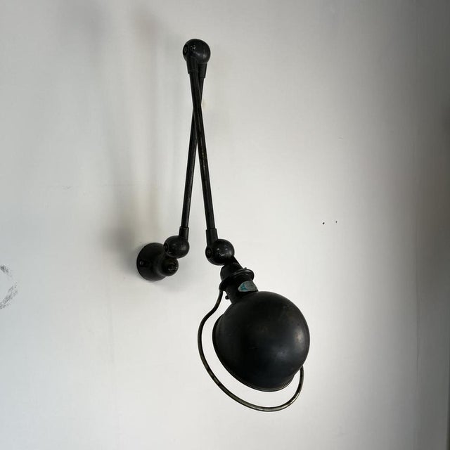 Beautiful original painted grey Jielde two arm wall light. Designed by the French engineer, Jean-Louis Domecq, in the...