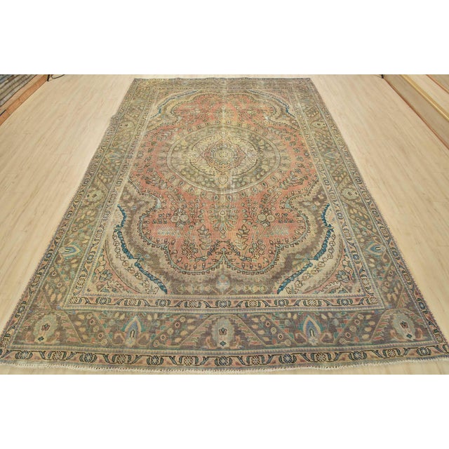 An authentic vintage traditional Tabriz rug hand-knotted with an all-wool pile on a cotton foundation. This oriental rug...