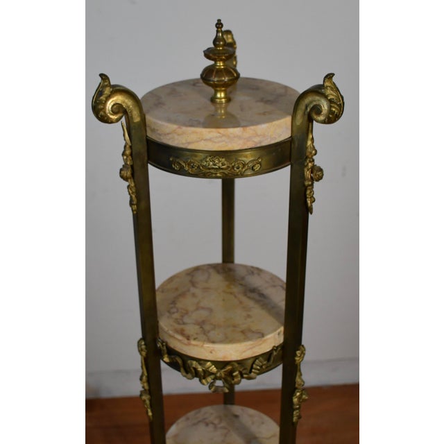 Elegant late 19th-century antique pedestal étagère, inspired by French Louis XVI / Neoclassical design. This tall display...