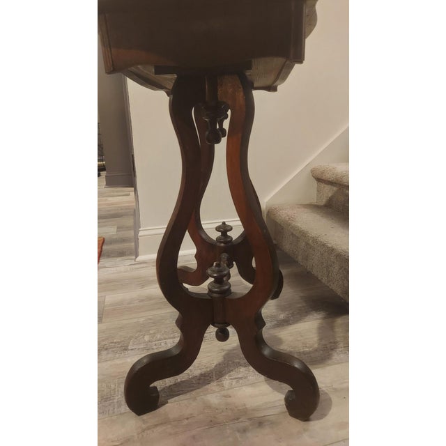 A handsome Victorian parlor side table featuring the elegant lyre-form double-pedestal base that was so fashionable in the...