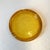 A warm amber colored glass ashtray, with pebbled textural base. C.1970's. Dimensions: 7 1/8"diameter x 1 1/8"H