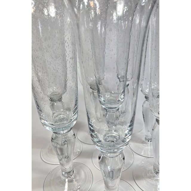Welcome to a bubbly glass of bubbly with a sweetly flared top! Each blown glass flute is evenly seeded with bubbles with a...