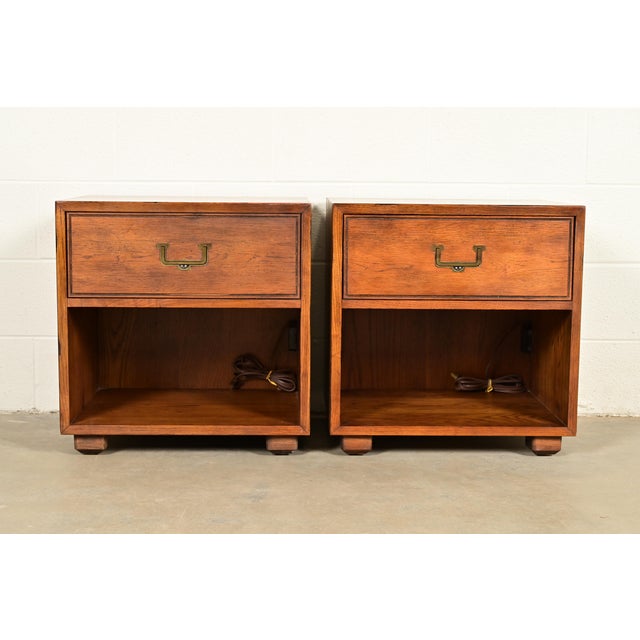An exceptional pair of Mid-Century Modern Campaign oak nightstands or end tables By Henredon, "Artefacts" Collection USA,...