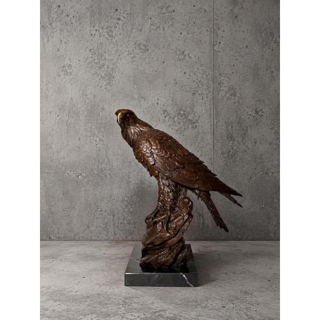 Impressive bronze eagle sculpture by Turner , depicting a powerful bird of prey perched dramatically on a rocky outcrop....