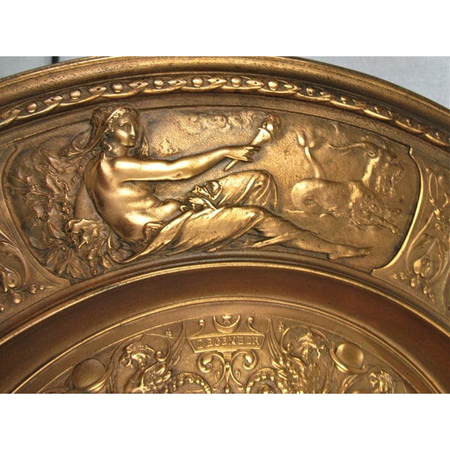 A large antique copper finish zodiac charger with attached loop for hanging. Very heavy, 14 pounds. Unknown metal with...