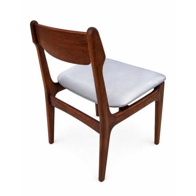 A fully restored teak dining chair set designed by Erik Buch in the 1960s. Solid teak frame with pedestal legs and a...