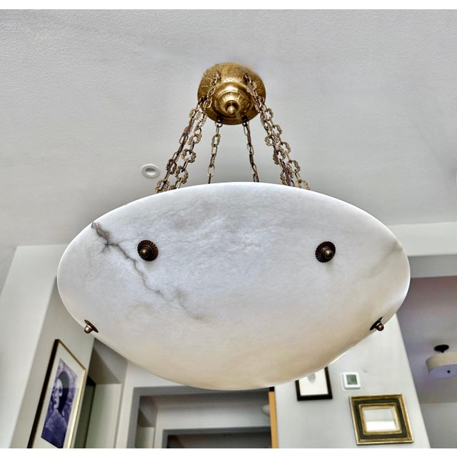 Large alabaster pendant light or chandelier with aged patinated brass fittings in the Directoire style. The white...