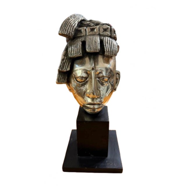 A fabulous bust of Aztec K’inich Pakal. The warrior bust on a black wooden base, and the brilliant, mirror like exterior...