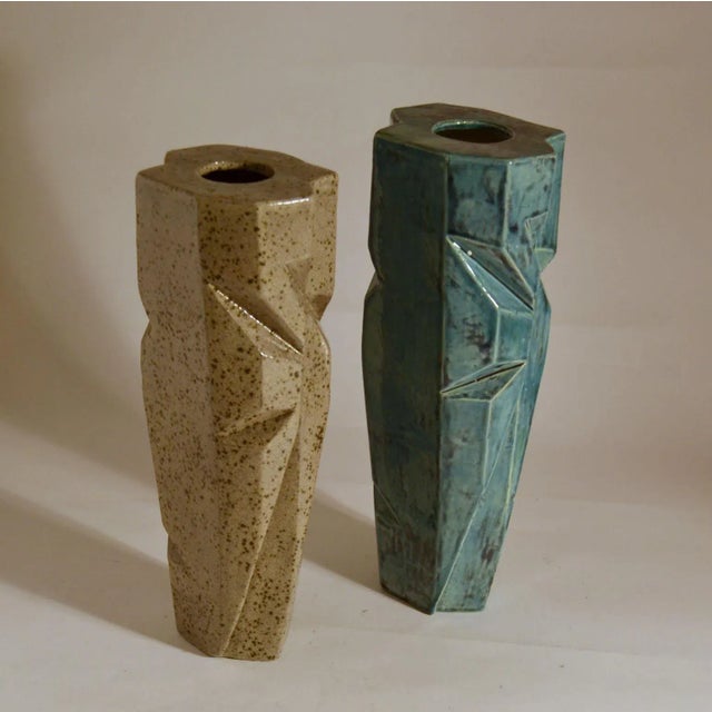 Hand formed elongated studio pottery vases in angular form with sharp incisions made in limited edition, signed by Dutch...