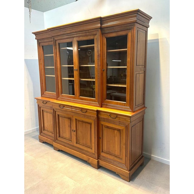 This impressive solid wood display cabinet combines timeless craftsmanship with generous storage capacity. Made from warm-...
