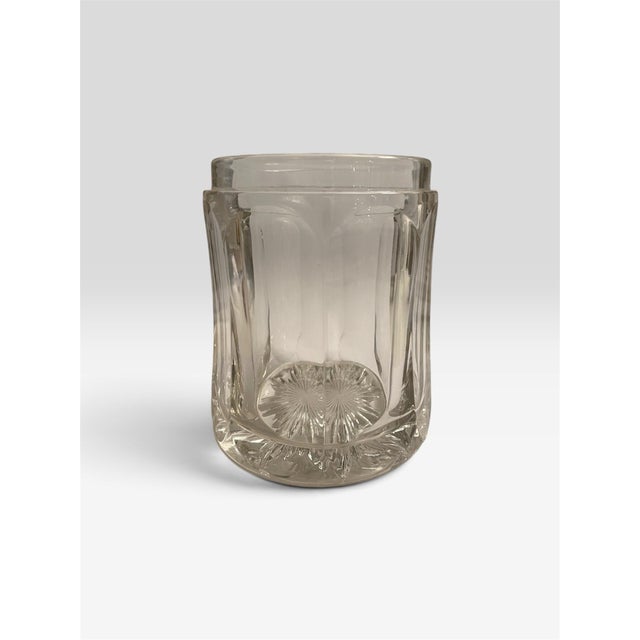 A refined leaded glass tobacco container with a gold finish metal lid. Meant to hold leafs for preservation.
