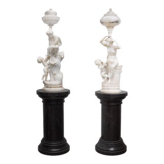 Pair of Monumental Antique Italian Carved Alabaster Venus & Cupid Figural Torchiere Lamps on Black Marble Pedestals For Sale