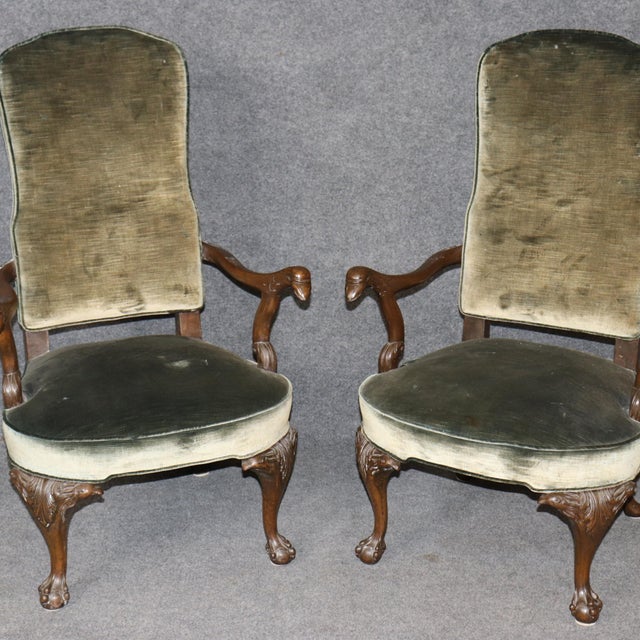 This is a gorgeous and very classic pair of carved eagle and ball and claw armchairs in the Georgian style from England....