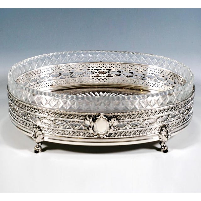 Elegant silver jardinière in an elliptical shape standing on four goat's feet with acanthus leaf connections, straight...