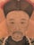 This is a Qing Dynasty (1644-1911) ancestor portrait. Ancestors were usually shown in their best dress, which gives us a...
