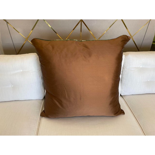 This pillow features an eye-catching ikat-inspired pattern in earthy tones, including shades of brown, teal, and rust on a...