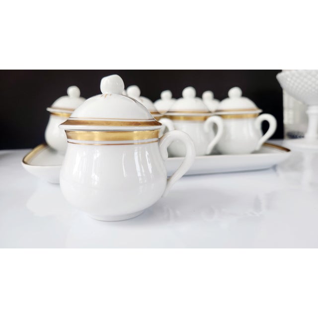 A vintage Portuguese porcelain, hostess ware pot de crème set comprising eight covered custard cups and a matching tray,...