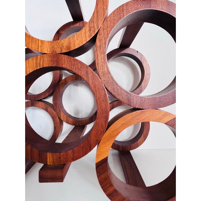 Elevate your wine storage style with this vintage 1960's mid-century Kustom Kraft walnut wine bottle rack. Artfully...