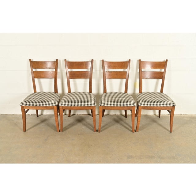 An exceptional set of four Mission or Arts & Crafts style dining chairs By Stickley USA, Circa Late 20th Century Solid oak...