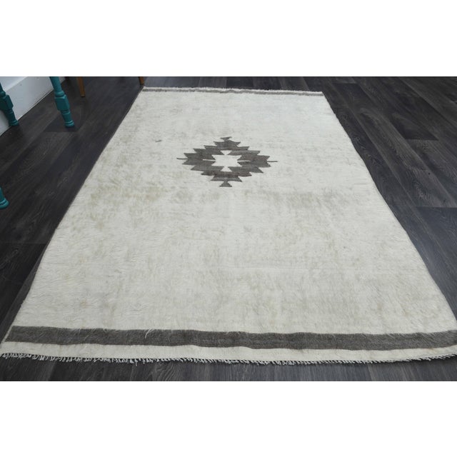 Vintage Hand-Knotted area rug is a semi-antique vintage area rug. The '70s Eastern region of Anatolia's unique rug is...