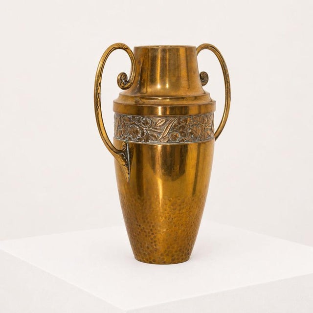 Refined pair of French Art Nouveau vases in hammered brass, dating back to approximately 1920-1930. The shape is elegant...