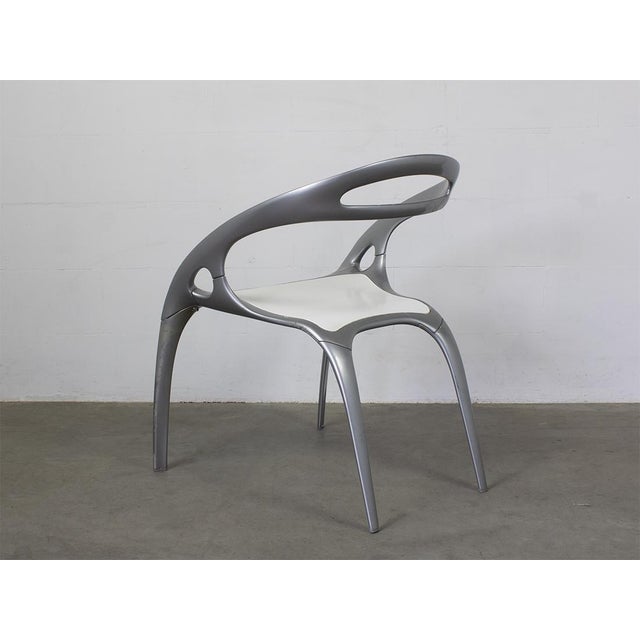Silver powder coated magnesium frame, White polypropylene seat. This piece has an attribution mark, I am sure that it is...