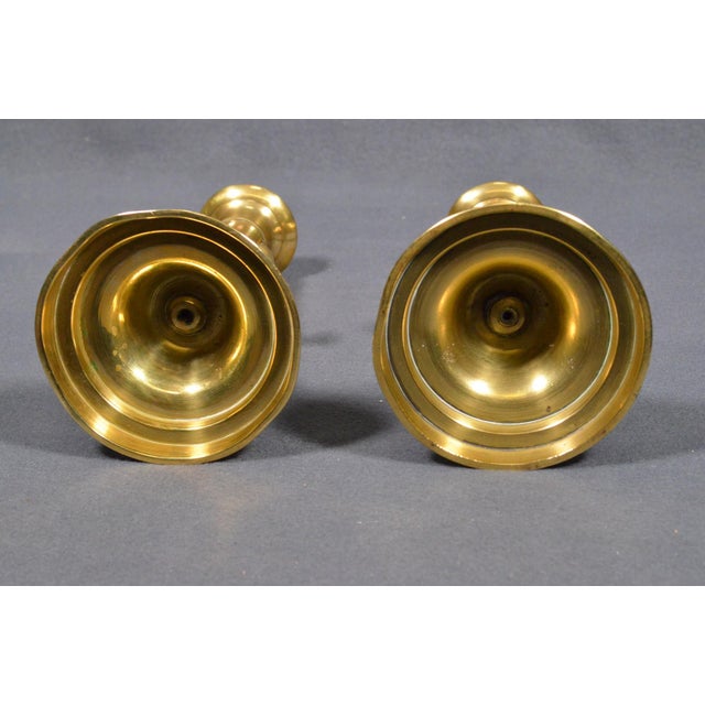 Charming pair of late 19th-century French brass push-up candlesticks, dating to circa 1880–1900. Each candlestick features...