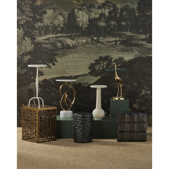 The Osa Drinks Table is a work of art, with its surface covered in over 400 pieces of natural bone that were ground into...