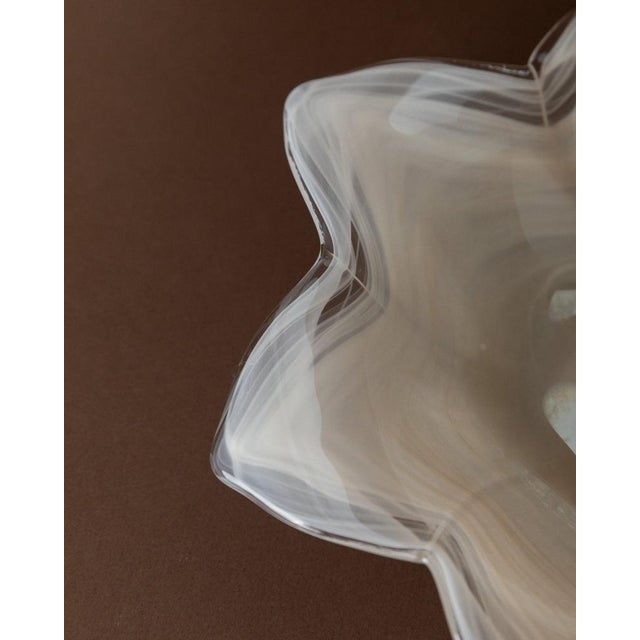 This vintage Murano glass bowl in the shape of a flower from the 1980s is a true work of art. with its white, transparent...