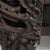 Carved daybed with upholstered bolsters in Deep Ebony Black. The deep ebony black surface highlights scroll-carved...