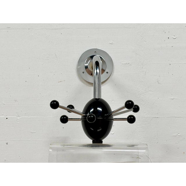 A striking vintage wall-mounted coat rack in the typical sputnik/atom design of the space age era. This version, with its...