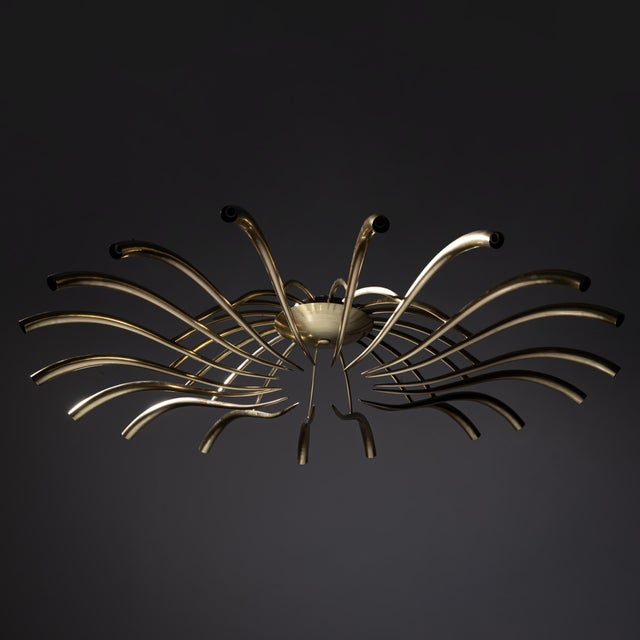 Large and rare chandelier designed by Oscar Torlasco for Lumi, circa 1955. Crafted from polished brass, the fixture...