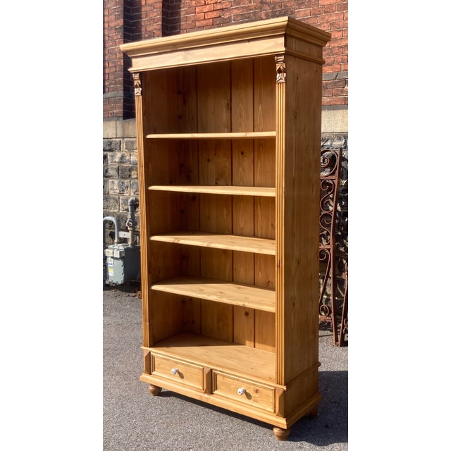 Antique pine bookcases are hard to find so the shell of this piece was provided by a vintage pine armoire. With one board...