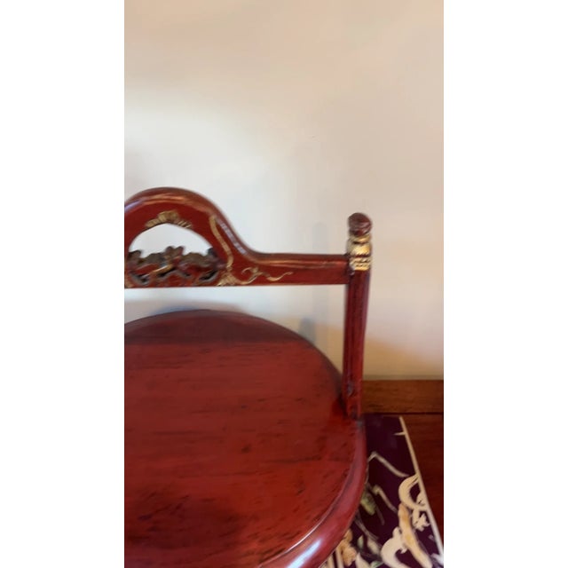 A striking, closely matched pair of antique Chinese wedding gift buckets in vibrant cinnabar-red lacquer with ornate gilt-...