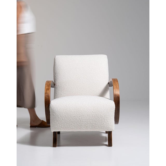 Bentwood-arm lounge chair in Warm Ivory Boucle. Finished in warm ivory boucle, this bentwood-arm lounge chair is...