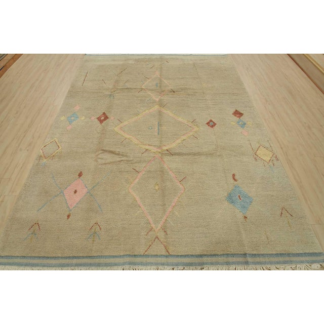 This contemporary geometric Moroccan rug is hand-knotted with an all-wool pile on a cotton foundation. This rug is new and...