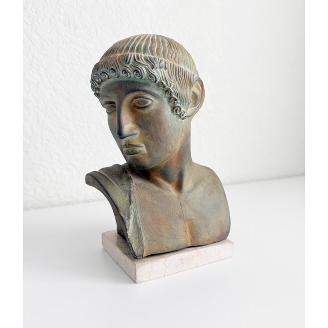 This elegant mid 20th-century decorative bust of Apollo is a refined example of classical revival sculpture. Depicting...