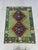This Afghan Chobi wool kilim features a rich teal green field with two navy blue diamond medallions, surrounded by...